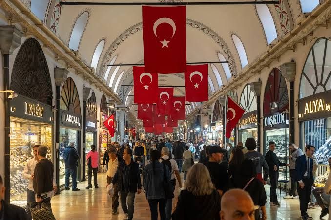 A Turkish flag flying near the financial district in Istanbul during a sunny afternoon.