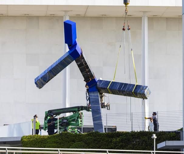 Crews dismantle the 24-foot-tall blue sculpture by artist Joel Shapiro on the Kennedy Center grounds.