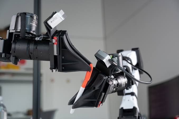 Robotic arm performing a precision task in a lab, representative of the data collection process at XDOF.