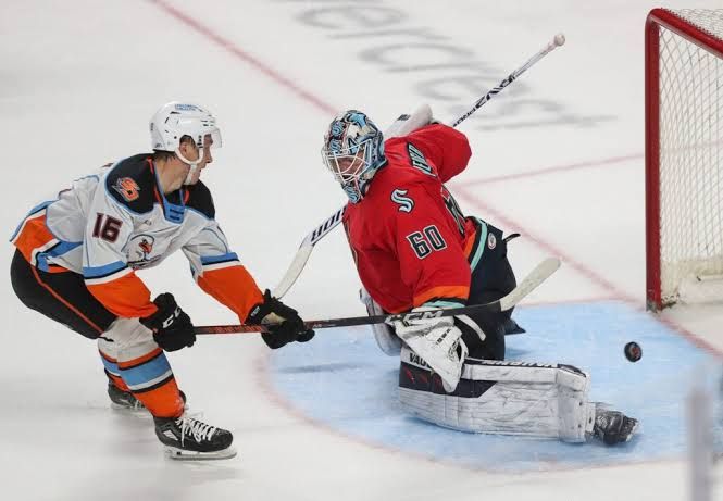 Sean Farrell and Sasha Pastujov in their respective team jerseys during NHL action.