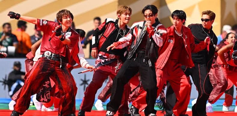 BTS members performing on stage at the Grammy Awards.