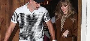 Taylor Swift and Travis Kelce walk together at a public event during the weeks following their wedding ceremony.