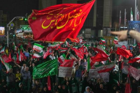 Pro-government demonstrators gather in a public square in Tehran, Iran, during the ongoing conflict.