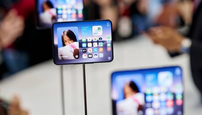 Apple CEO John Ternus holding the new iPhone Duo at the Apple Park event in California.