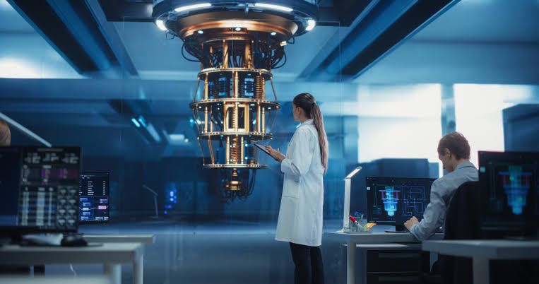 A scientist in a lab coat examines a complex, illuminated quantum computing processor inside a professional laboratory.