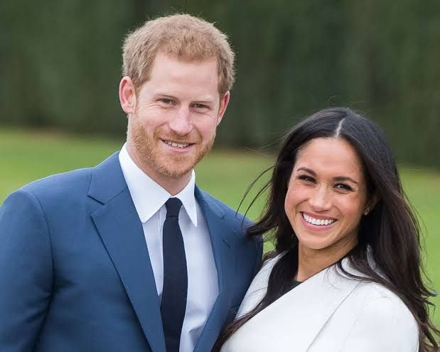 Prince Harry and Meghan Markle walking together at a public engagement in the U.K. prior to their move to California.