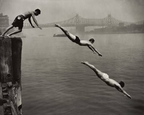 Arthur Leipzig's 1948 photograph of three men diving from a wooden pier into the East River.