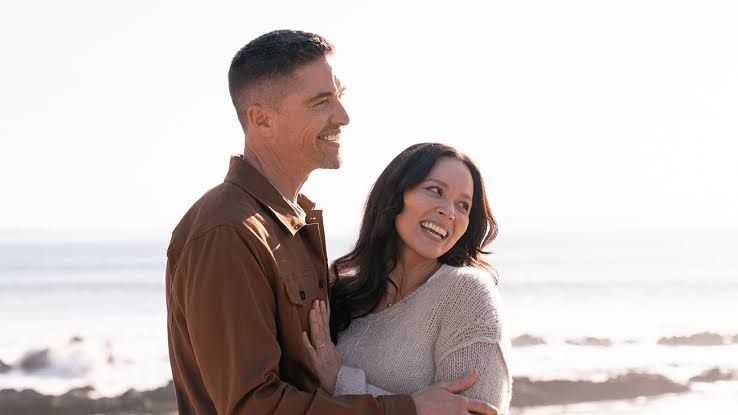 Eric Winter and Melissa O'Neil standing together as their characters Tim Bradford and Lucy Chen in a scene from The Rookie.