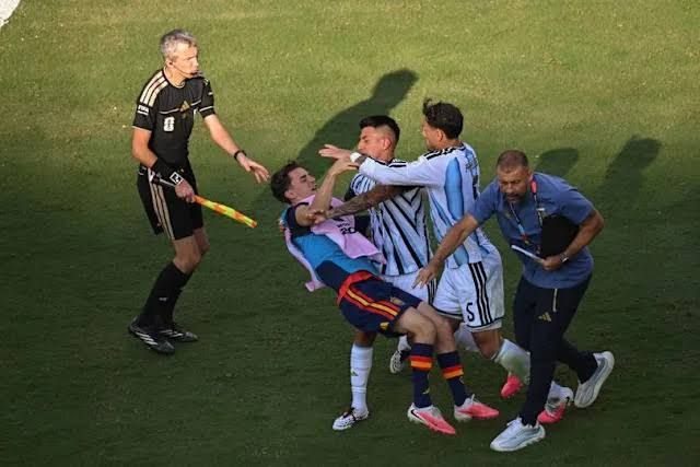 Argentina players Leandro Paredes and Thiago Almada confronting Spain's Pablo Gavi after the 2026 World Cup Final.