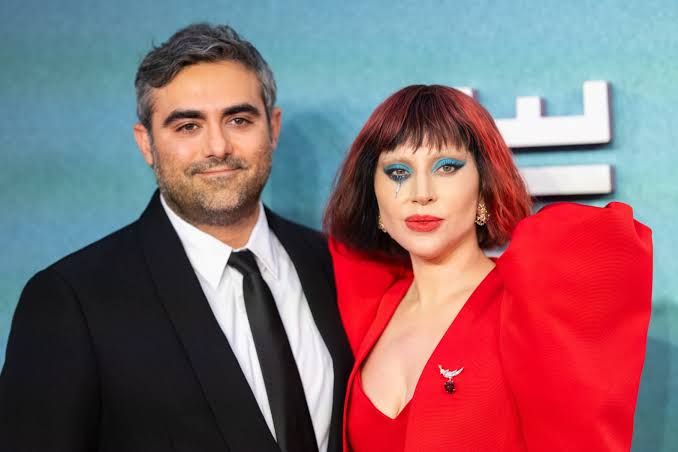 Lady Gaga and Michael Polansky posing together at a film premiere prior to the birth of their child.