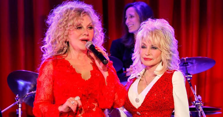 Stella Parton and Dolly Parton posing for a photograph together in Nashville during a 2014 event.