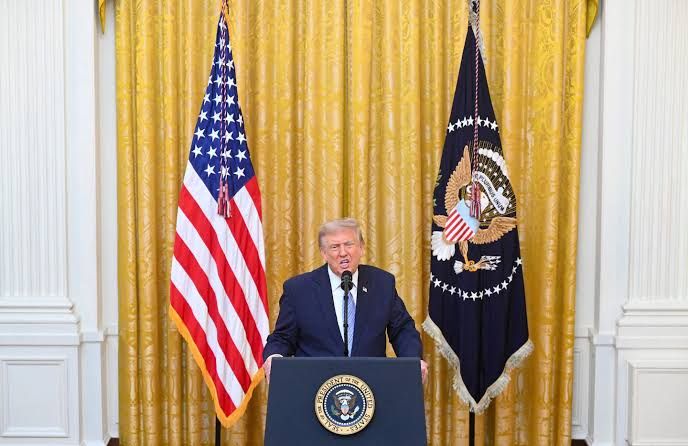 President Donald Trump speaking at a podium in the White House East Room during his prime-time address on election integrity.