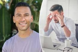 Man with a headache at his desk reflecting on the negative health impacts of extreme wellness trends.