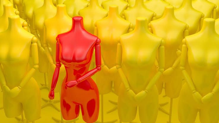 An AI-generated red mannequin stands out against a sea of yellow mannequins to visualize fashion design innovation.