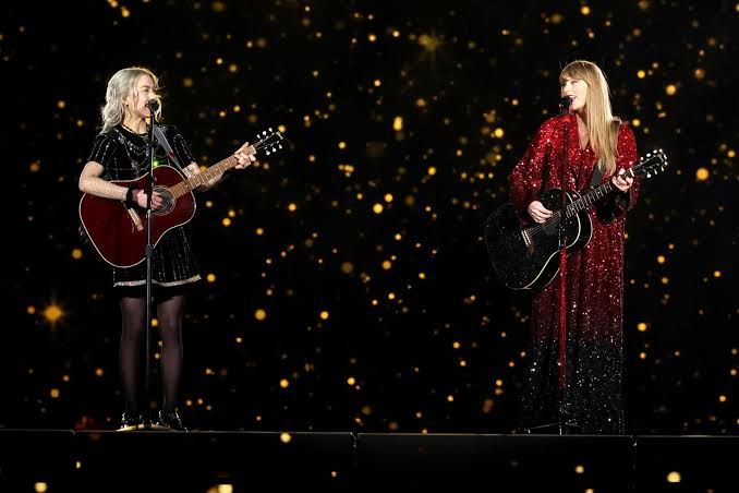Phoebe Bridgers and Taylor Swift performing together on stage during the Eras Tour at MetLife Stadium.