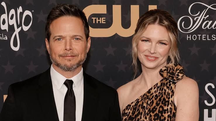 Kelley Wolf and Scott Wolf stand together on a red carpet during a past public event.