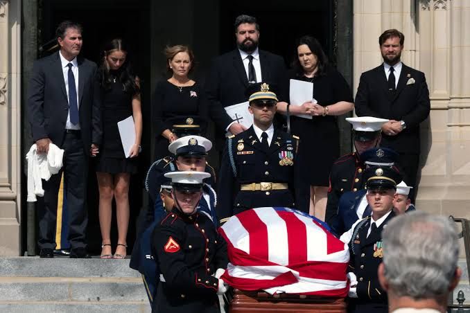 An Armed Forces Body Bearer Team carries the flag-draped casket of Senator Lindsey Graham at the National Cathedral.