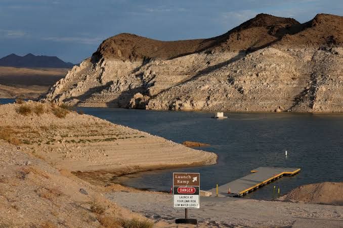 Extended Echo Bay launch ramp at Lake Mead, Nevada, showing significant water recession and visible bathtub rings on cliffs.