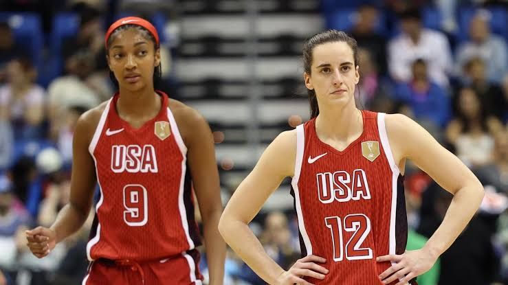 Caitlin Clark and Angel Reese standing side by side during a 2026 FIBA World Cup game for Team USA.