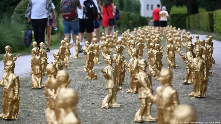 Gold-colored Mozart figurines arranged in a garden display before the majority were stolen in Salzburg.