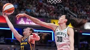 Caitlin Clark dribbling the ball in front of Breanna Stewart during the Indiana Fever game against New York.