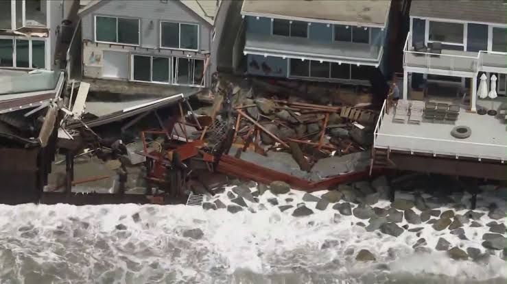 Damaged beachfront homes and collapsed patios along the Dana Point shoreline after severe coastal erosion in September 2026.