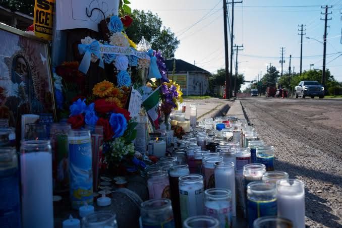 A memorial with flowers and candles for Lorenzo Salgado Araujo, the man fatally shot by an immigration agent in Houston.