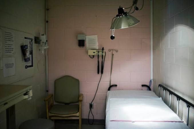 A standard clinical exam room with a desk and chairs, serving as the setting for psychiatric diagnostic assessments.