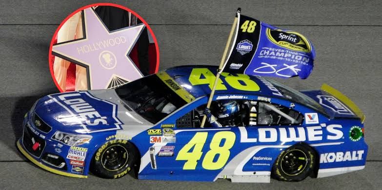 Seven-time NASCAR Cup champion Jimmie Johnson standing in front of a race car during an official event.