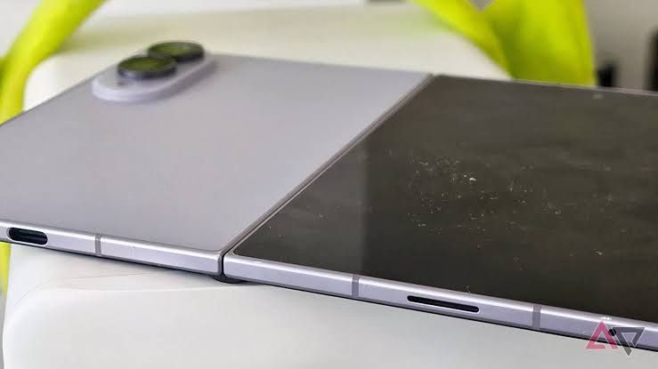 Samsung Galaxy Z Fold 8 laying on a flat surface with the inner screen displaying a grid of app icons.