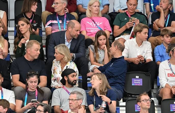 Prince Edward sits in front of Princess Charlotte and Prince George at the Commonwealth Games velodrome in Glasgow.