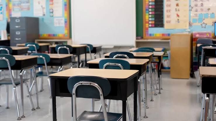 A humanoid robot named Sally sits in a classroom setting designed for instructional support in a New York school.