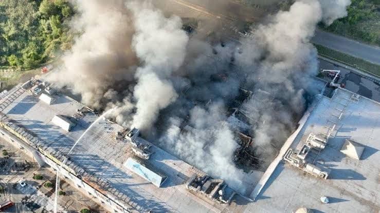Firefighters operate at a burning shopping center in Kryvyi Rih following a Russian drone attack.
